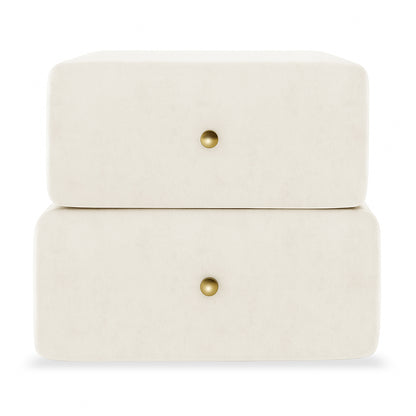 Luxo Tyla Modern Velvet Bedside Table Beige features two stacked off-white velvet drawer modules, each with a central brass knob, showcasing a plush, compact design perfect for enhancing bedroom elegance.