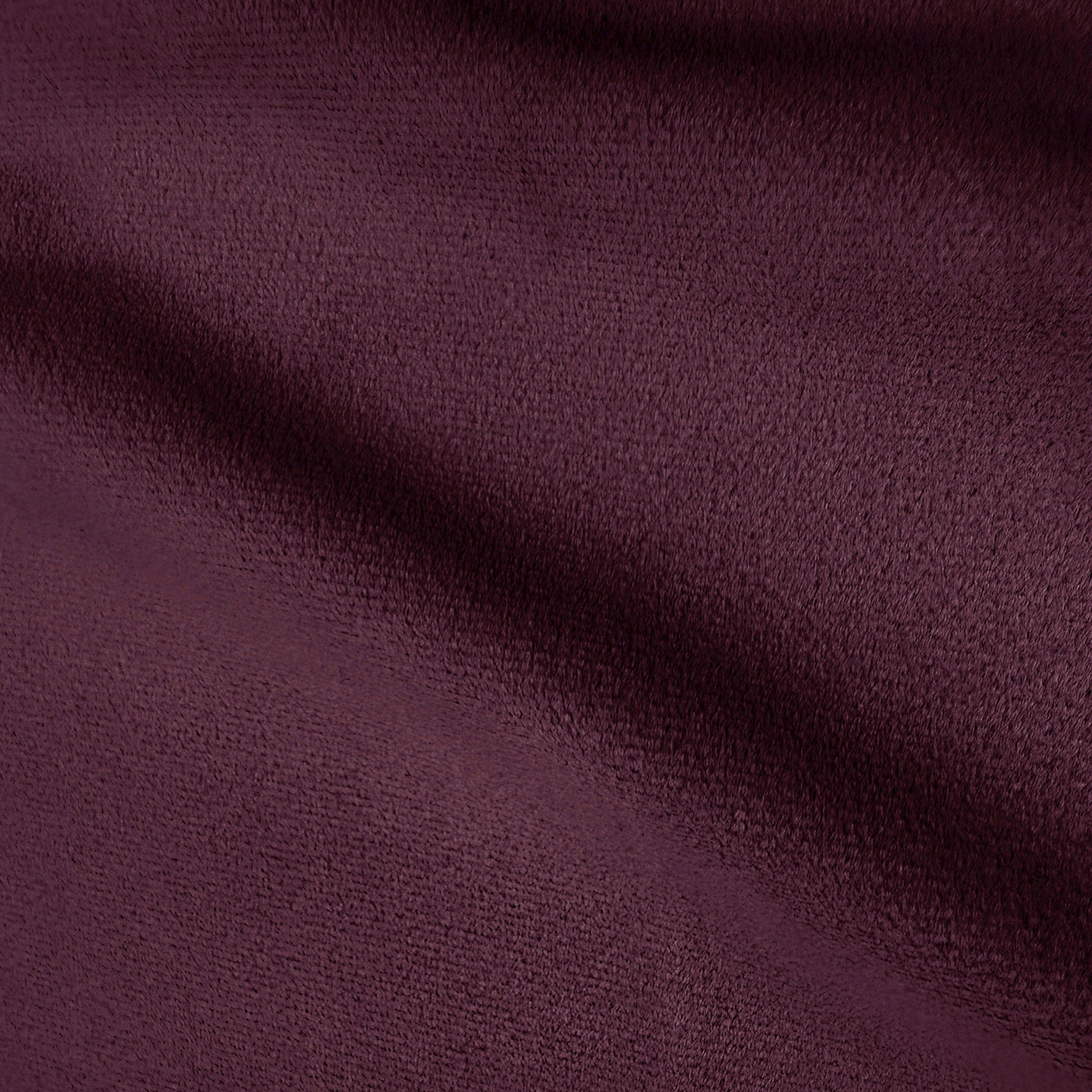 Close-up texture of plum velvet upholstery