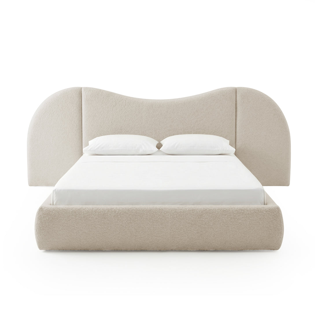 Front view of beige upholstered bed with pillows on white background