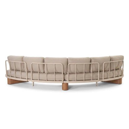 Curved sofa with metal frame and beige cushions on a white background
