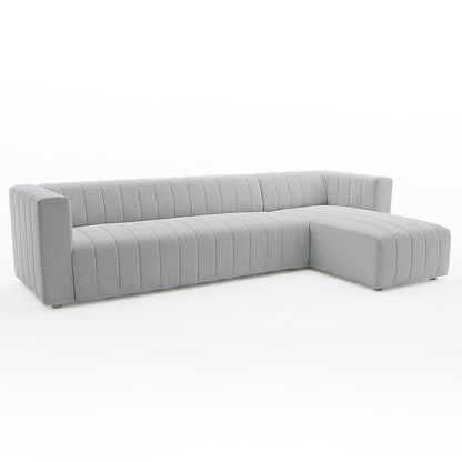 Parisa 4 Seater Tufted Boucle Sofa with Chaise in Light Grey, featuring pebble-textured fabric, low squared arms, vertical channel-tufting, and an extended chaise lounge for a contemporary, comfortable look.