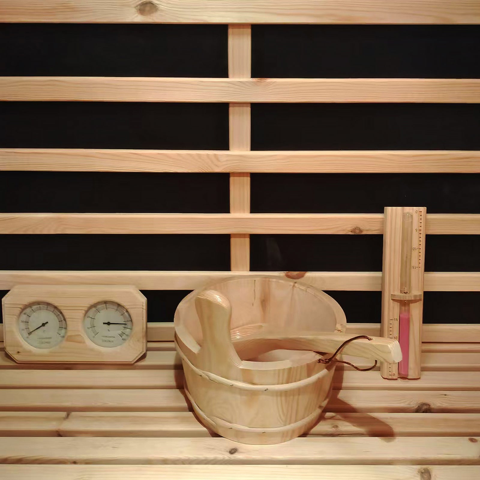 Luxo Kiima 6 Person Hybrid Finnish Outdoor Sauna in Natural features a wood-lined interior with a sauna bucket, ladle, dual gauge, and hourglass against horizontal slats, offering an authentic sauna experience.