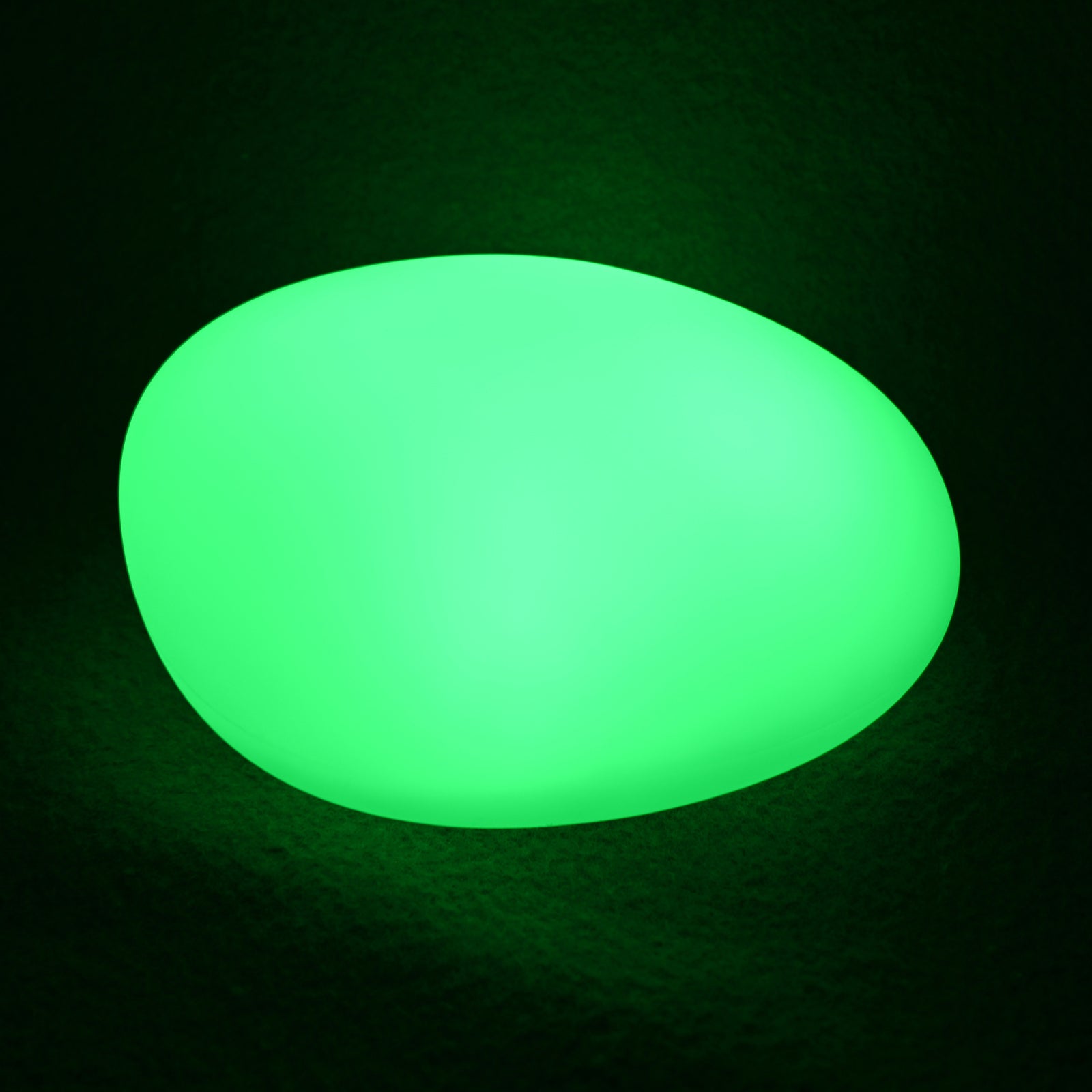 Solar Outdoor LED Rock Light Waterproof Garden Lamp glowing bright green, resembling a smooth pebble, on a dark surface, showcasing its decorative and functional design for gardens and pathways.