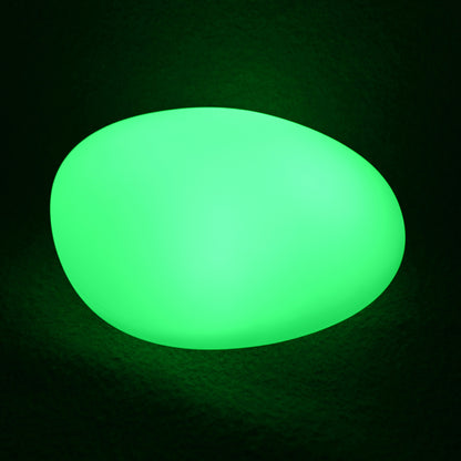 Solar Outdoor LED Rock Light Waterproof Garden Lamp glowing bright green, resembling a smooth pebble, on a dark surface, showcasing its decorative and functional design for gardens and pathways.