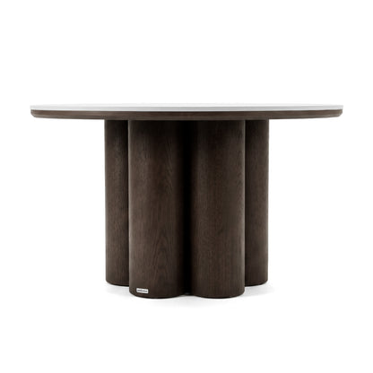 Modern round table with thick top and cylindrical base on a white background