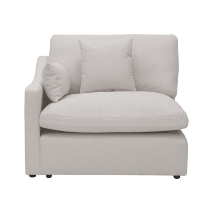Light beige modular corner chair with plush cushions and two throw pillows on a white background