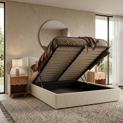 Storage bed with lifted mattress platform in a styled bedroom