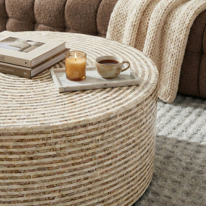 Mosaic coffee table styled with books and candle in living room