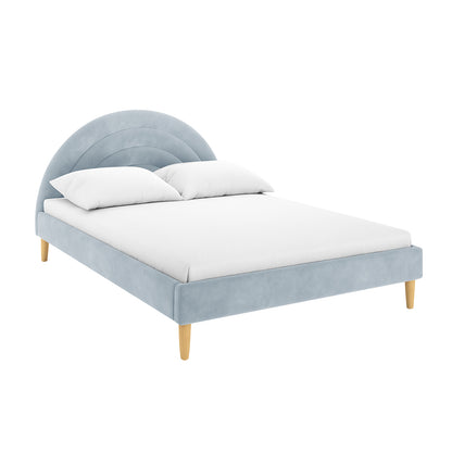 Estilla Velvet Rainbow Bed in Ice Blue features a semi-circular, velvet-covered headboard, low-profile frame with four wooden legs, white mattress, and pillows, combining modern charm with practical design.