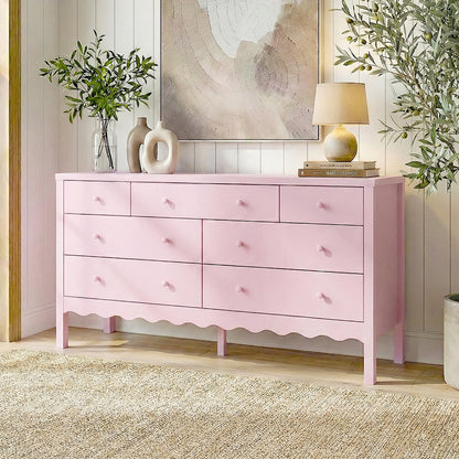 Pink dresser in a decorated room with rug, plants, and wall art