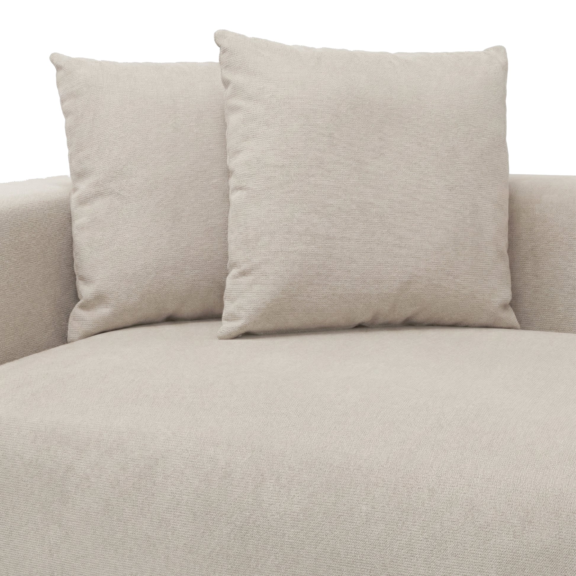 Close-up of beige sofa cushions and armrests on white background