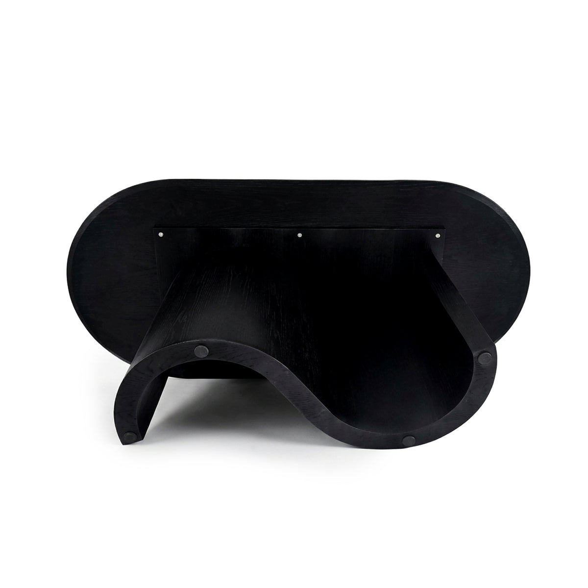 Full view of a sculptural black furniture piece with a wavy silhouette on a white background
