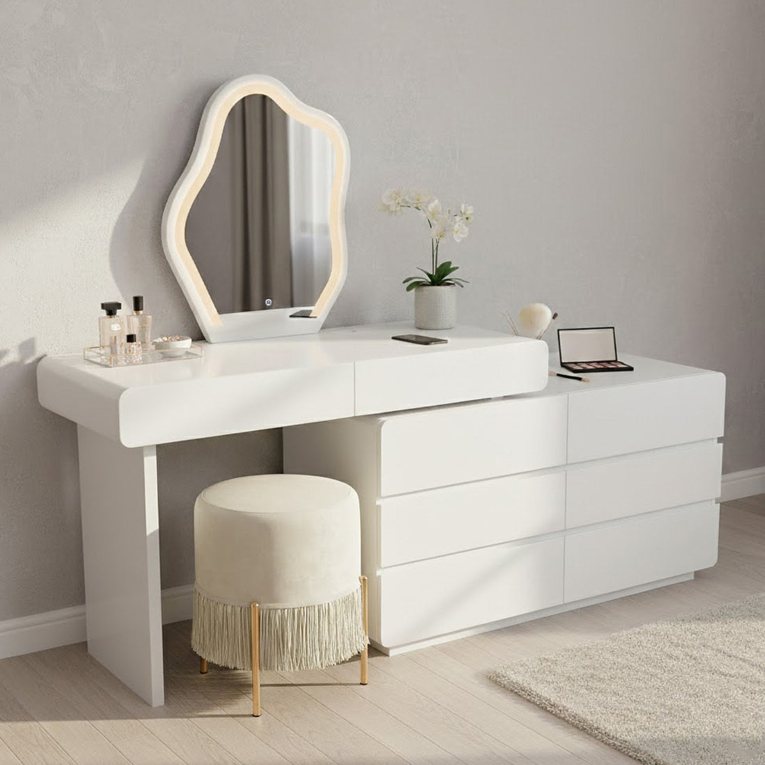 Eloura LED Mirror Dressing Table with Storage in White featuring an organic-shaped LED mirror, sleek drawers, perfume tray, eyeshadow palette, and a cream stool, all on display for a modern vanity setup.