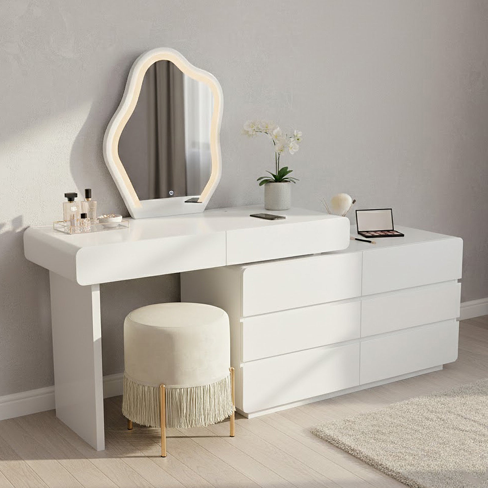 Eloura LED Mirror Dressing Table with Storage in White featuring an organic-shaped LED mirror, sleek drawers, perfume tray, eyeshadow palette, and a cream stool, all on display for a modern vanity setup.