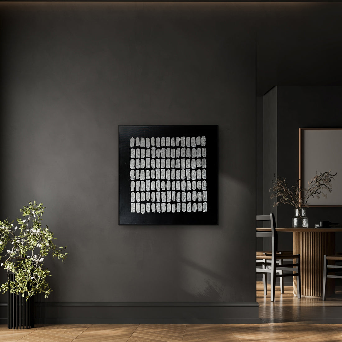 Elodie Framed Canvas Wall Art 105 x 105cm in Black features abstract white brushstrokes on a black background, adding texture and elegance to a modern, sophisticated interior setting.
