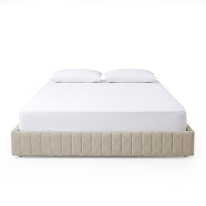 Minimalist beige upholstered bed with two white pillows on a white background