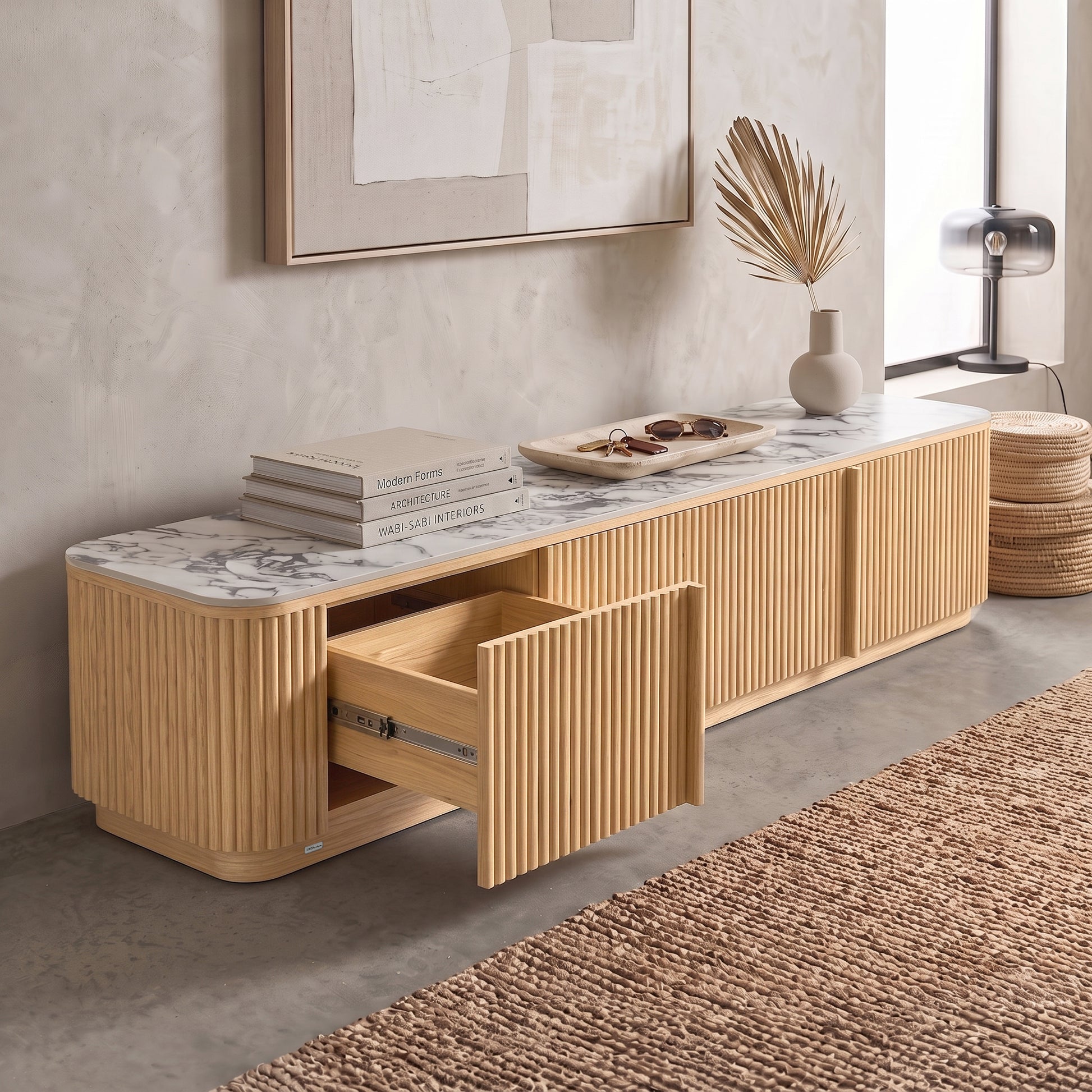 Modern wooden sideboard with marble top styled in a contemporary living room