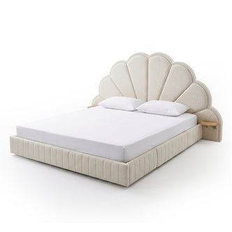 Full view of upholstered king bed with scalloped headboard, mattress, and pillows on white background