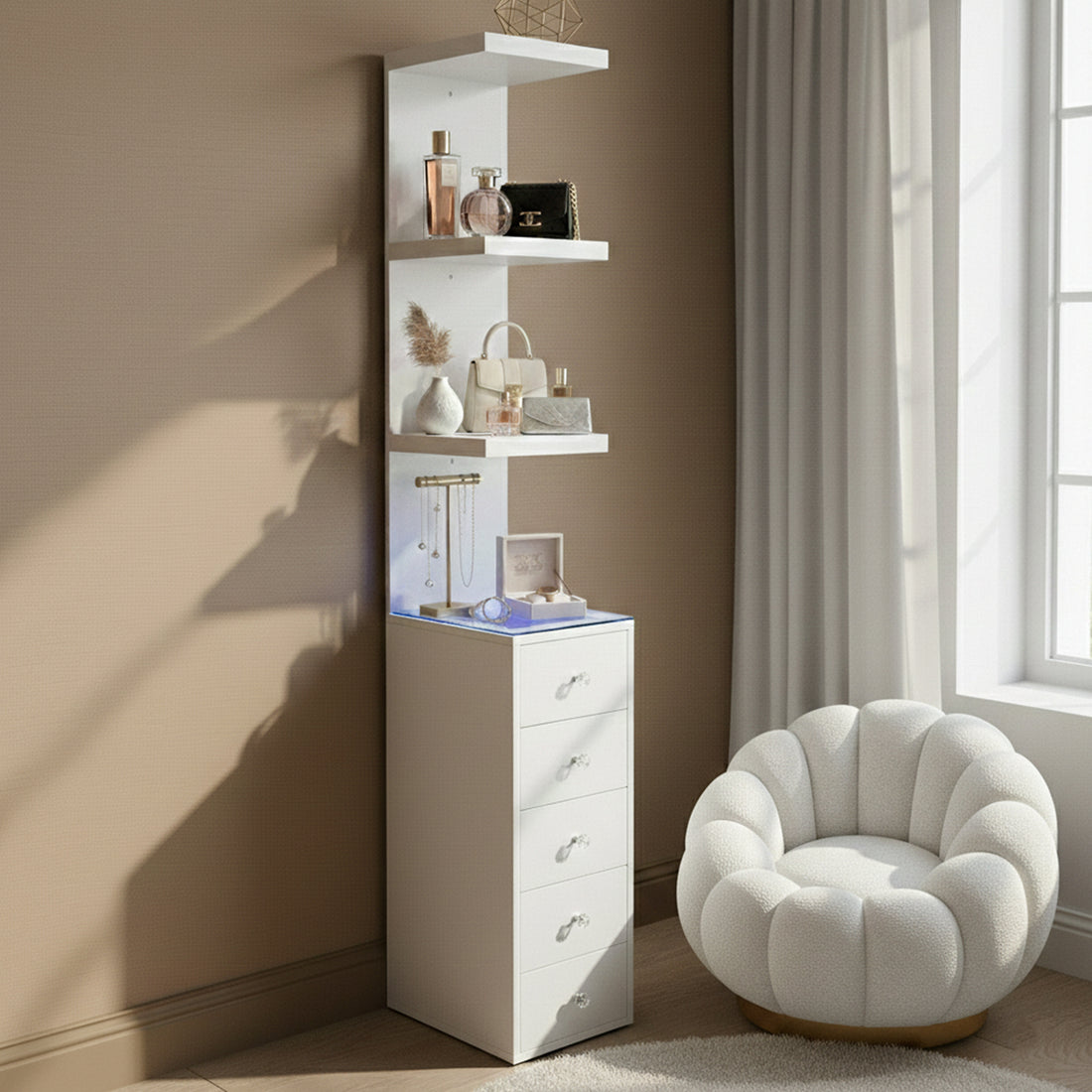 White storage unit in a room setting beside a chair with decorative items on shelves
