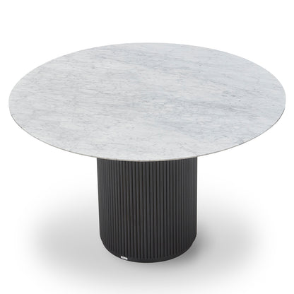 Gracie 120cm Round Marble Dining Table in Black features a sleek, round marble top with unique veining on a vertically fluted, cylindrical black base, embodying modern elegance and stability.