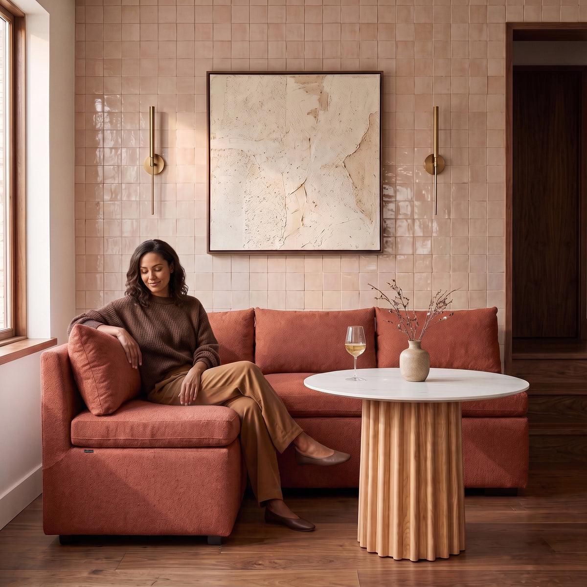 Terracotta sectional sofa with a person relaxing in a stylish living room