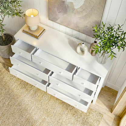 White dresser with open drawers in a styled room with decorative accents