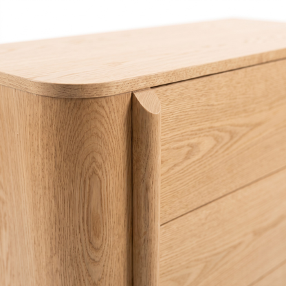 Close-up of the top corner of a wooden dresser on a white background