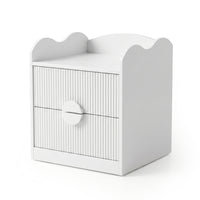 White modern nightstand with wavy top edge, grooved drawer fronts, and central circular handle