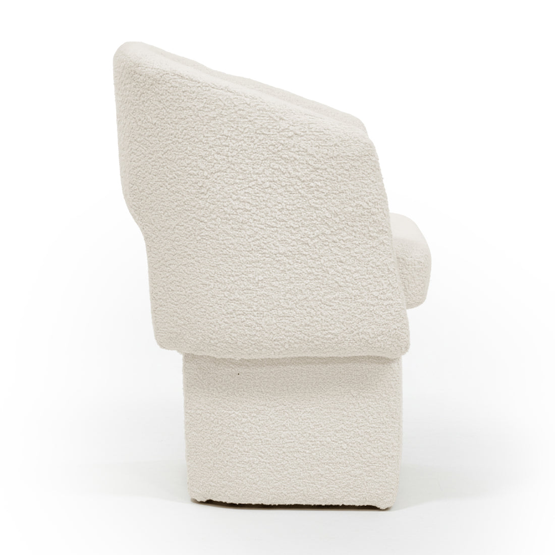 Side profile of the Avela Bouclé Fabric Curved Accent Armchair in Cream White, showcasing its modern block-style with a tall, angled backrest, subtly curved armrest, and solid rectangular base.