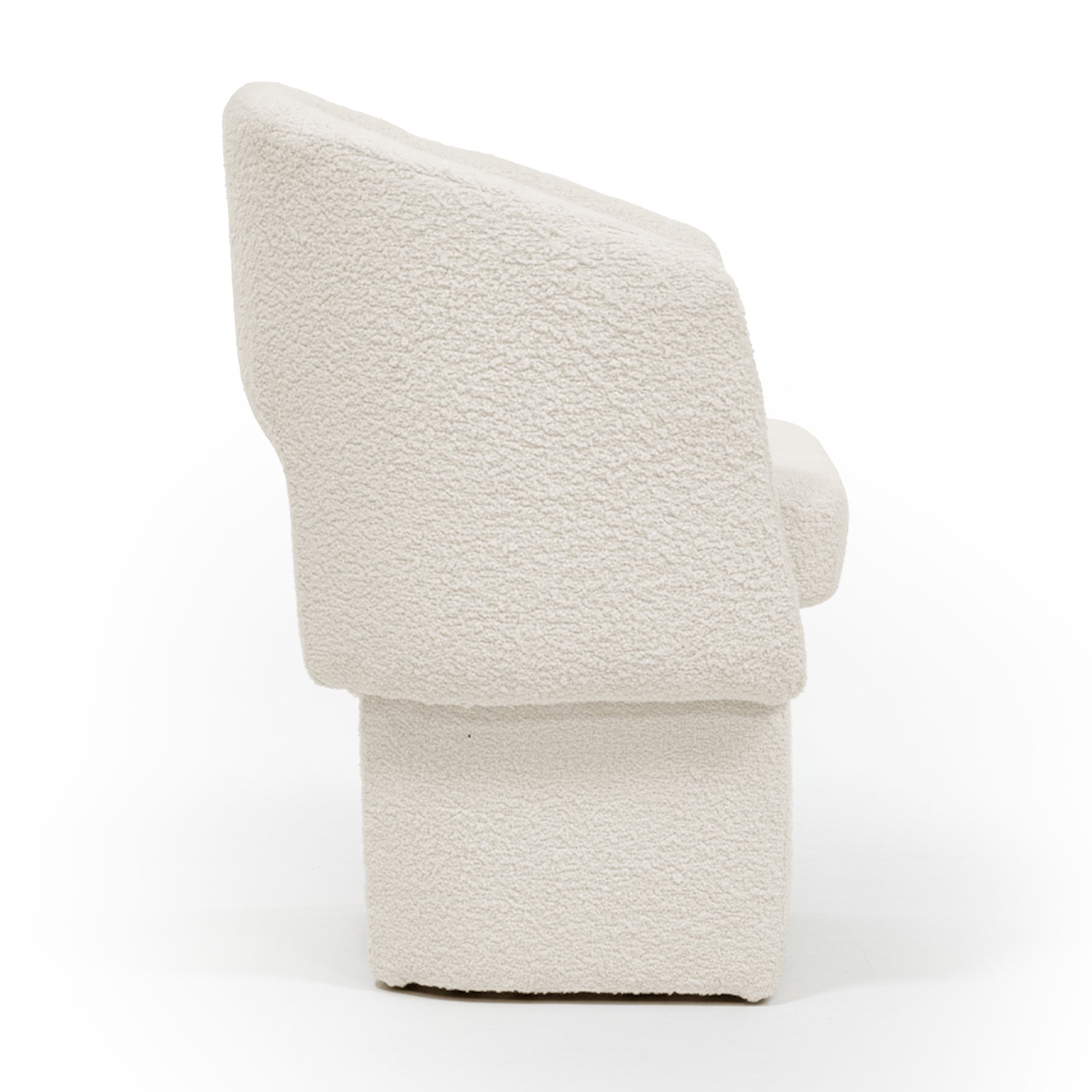 Side profile of the Avela Bouclé Fabric Curved Accent Armchair in Cream White, showcasing its modern block-style with a tall, angled backrest, subtly curved armrest, and solid rectangular base.
