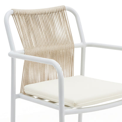 Evone 4 Seater Stone Outdoor Dining Table Set in Natural features a sleek stone tabletop and sturdy aluminum frame, complemented by four modern armchairs with natural-fiber cord backrests and white seat cushions.