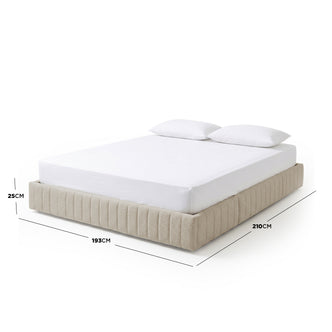 Beige upholstered bed with white mattress and pillows, dimensions overlay on white background
