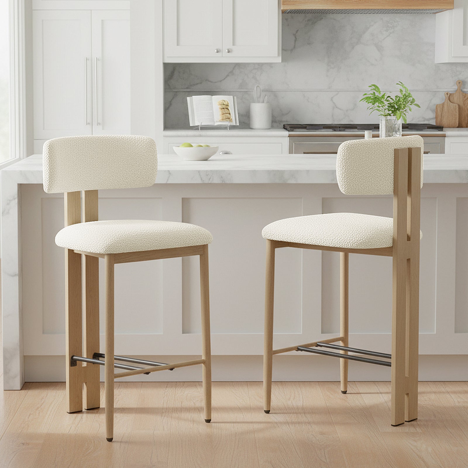 Haleo Curved Boucle Fabric Barstool Set of 2 in Cream White, featuring light wood frames, arched backs, and dark metal footrests, positioned before a modern kitchen island with white marble top.
