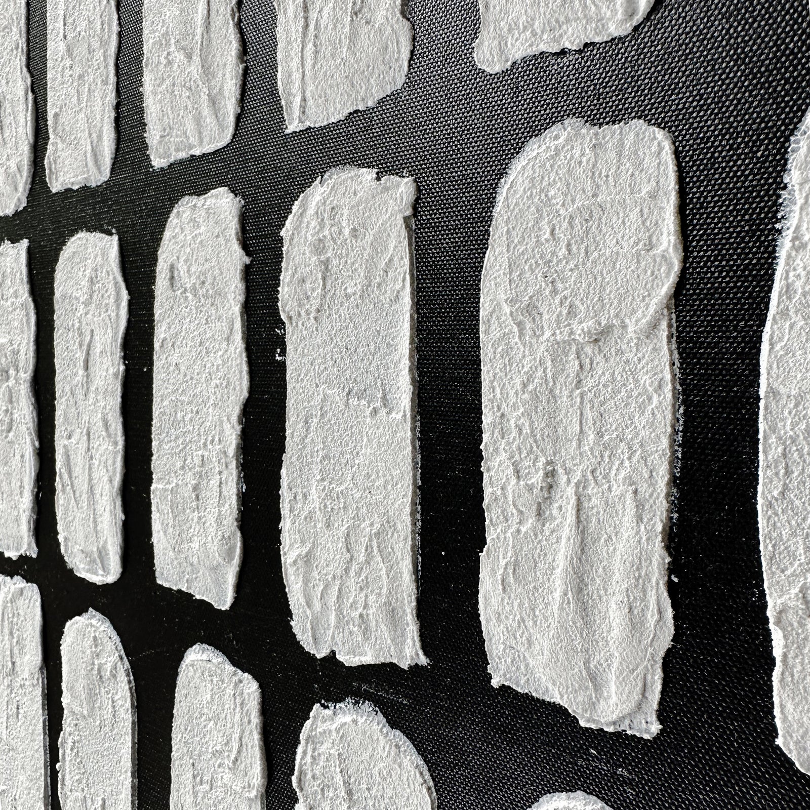 Elodie Framed Canvas Wall Art 105 x 105cm in Black features small white fibrous rectangles resembling handmade paper, adding texture and depth, set against a dark textured background.