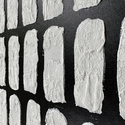 Elodie Framed Canvas Wall Art 105 x 105cm in Black features small white fibrous rectangles resembling handmade paper, adding texture and depth, set against a dark textured background.