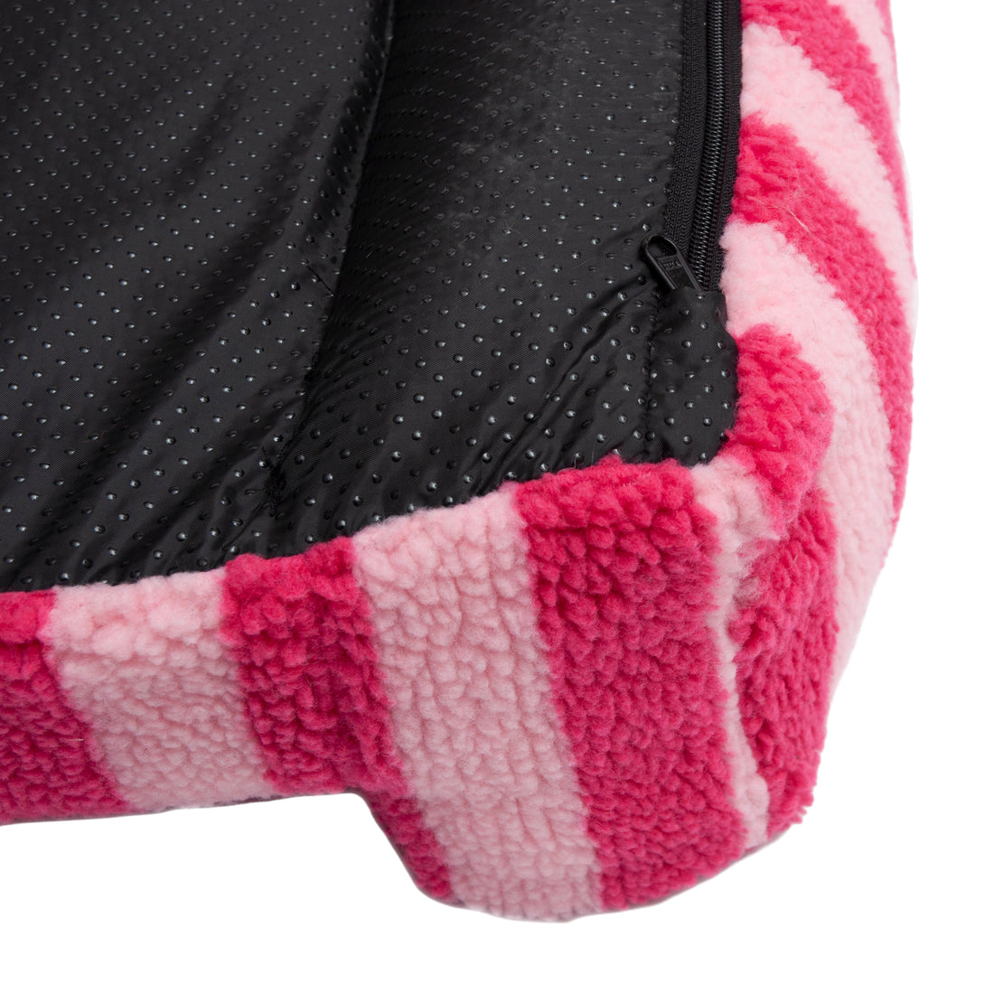 Close-up of pink and red striped exterior with black textured interior and zipper detail on white background
