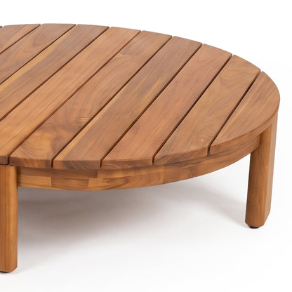 Close view of part of a round wooden coffee table on a white background.