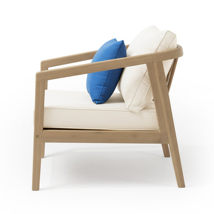 Delva 4 Seater Hardwood Acacia Outdoor Sofa Set in Cream, featuring a light-wood frame with slanted legs, off-white upholstery, and two cushions, including a bright blue accent pillow.