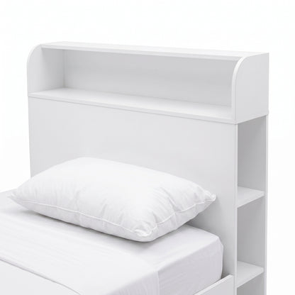 Close-up of the headboard and upper portion of a white bed with built-in shelving.