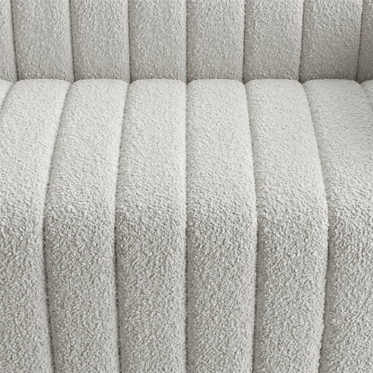 Close-up of light textured upholstered fabric with channel stitching