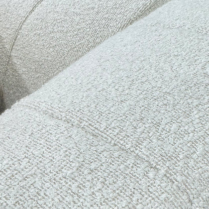 Close-up of the Parisa 4 Seater Tufted Boucle Sofa with Chaise, showcasing its cream white, looped-yarn bouclé upholstery, highlighting the plush texture and cozy seating surface.