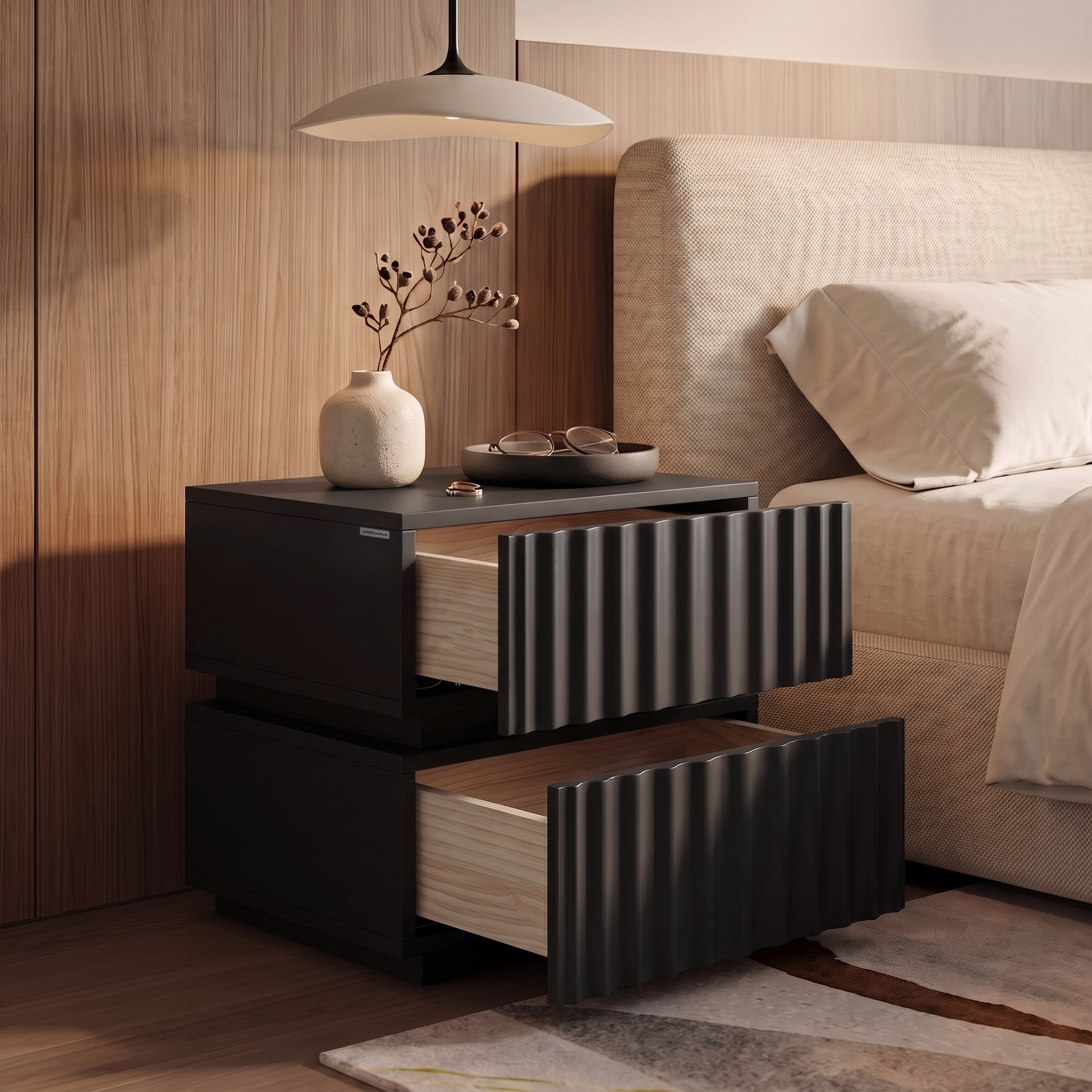 Modern dark nightstand with open drawers styled beside a bed in a bedroom.