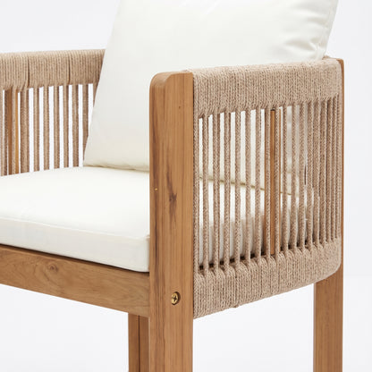 Upper portion of a wooden chair with woven rope detailing and white cushions