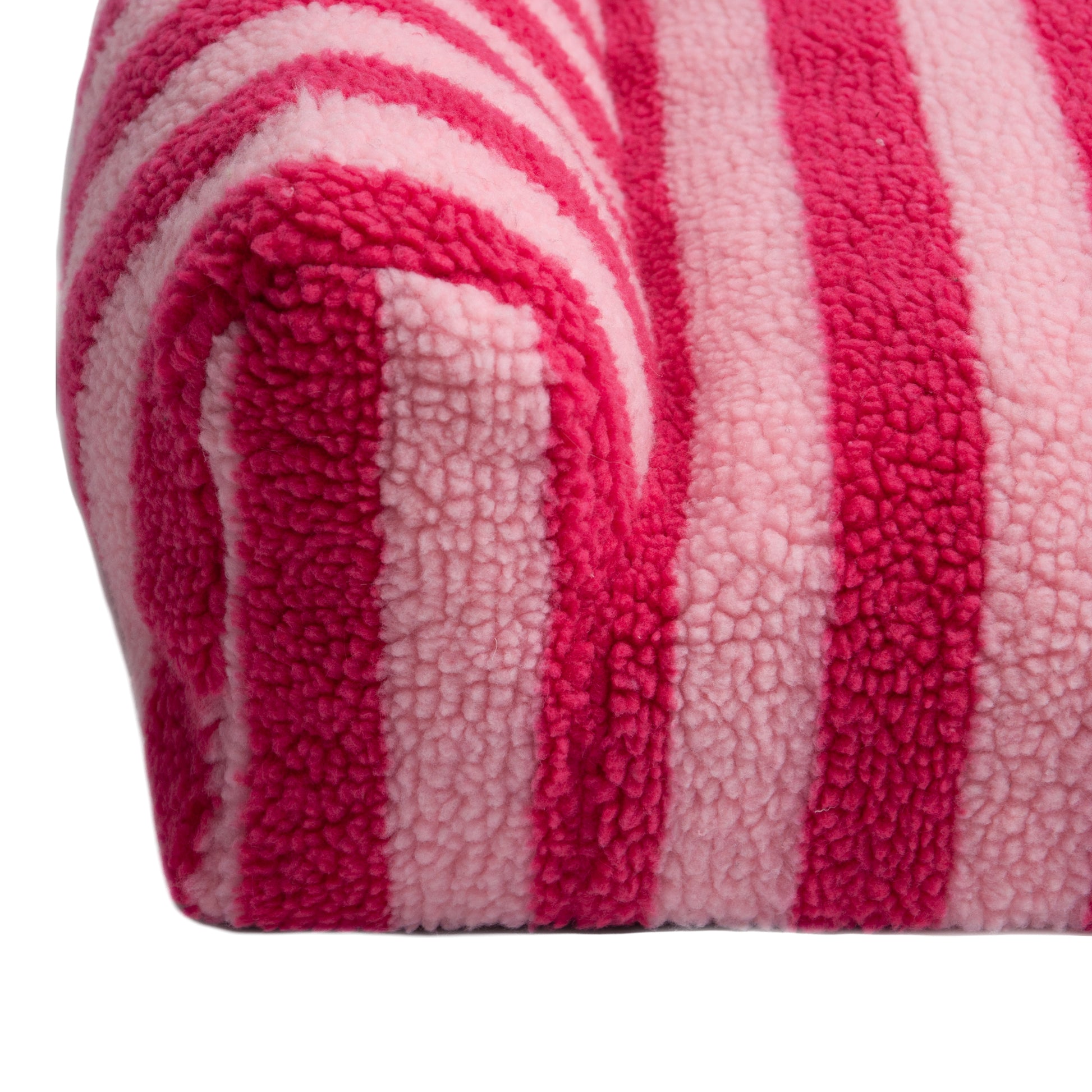 Close-up of plush pink and light pink striped furniture armrest on a white background