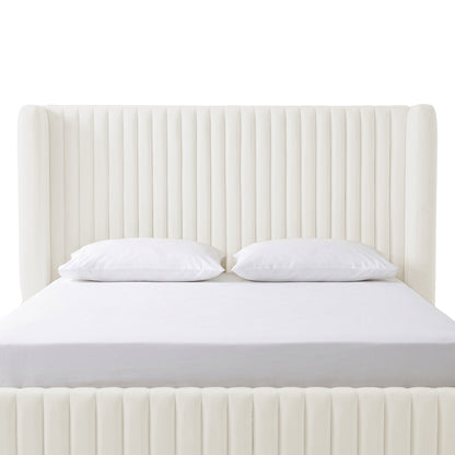Front-facing cream upholstered bed with tall channel-tufted headboard