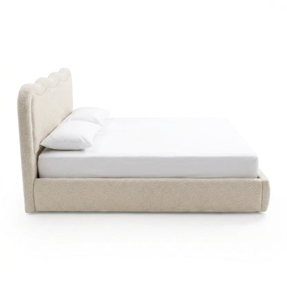 Side view of upholstered bed on white background