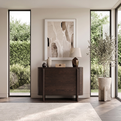 Dark wooden cabinet styled in a bright modern room with windows and decor