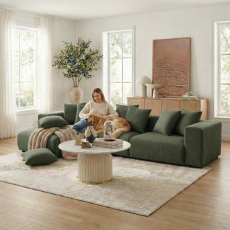 Dark green sectional sofa in styled living room with person and dog