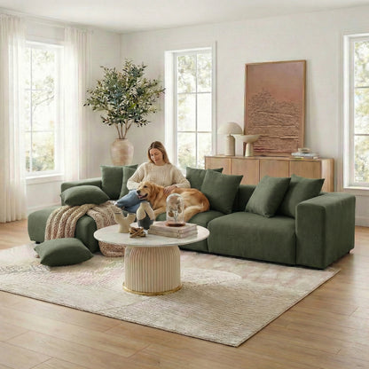 Dark green sectional sofa in styled living room with person and dog