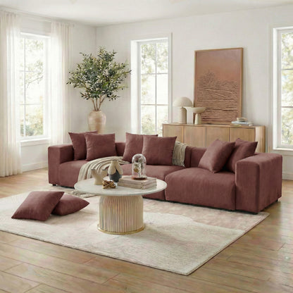Brown sectional sofa with throw and pillows in a bright living room setting
